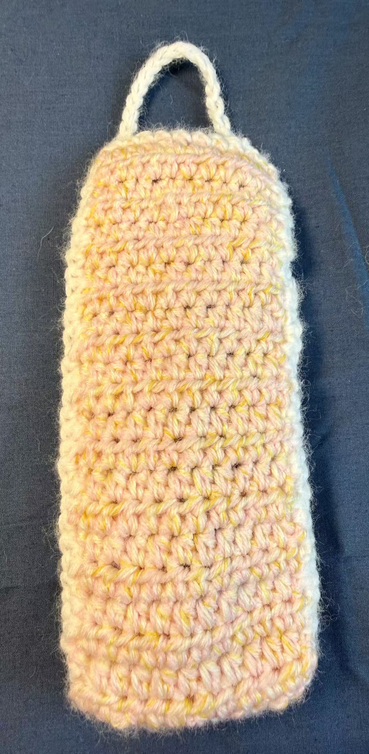 Back view of the crochet pouch with the flap open.